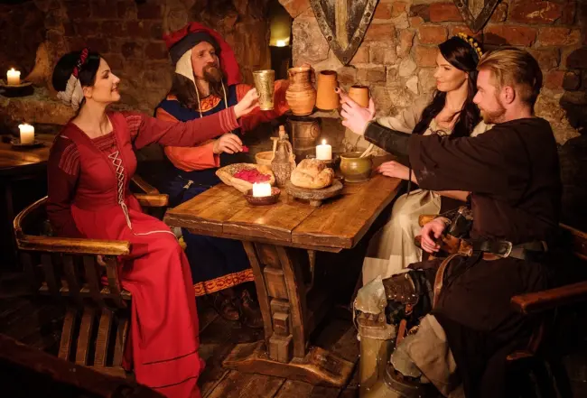 A group of medieval people toasting with almond milk
