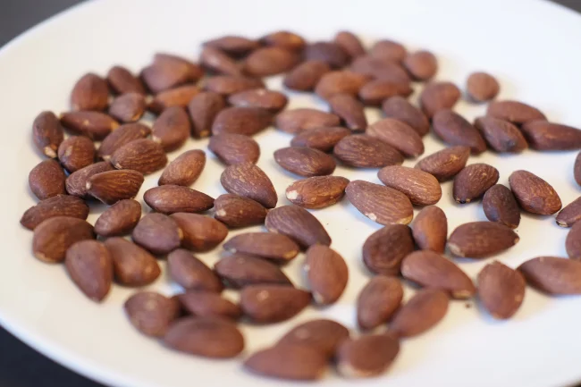 Letting the toasted almonds cool down on a plate