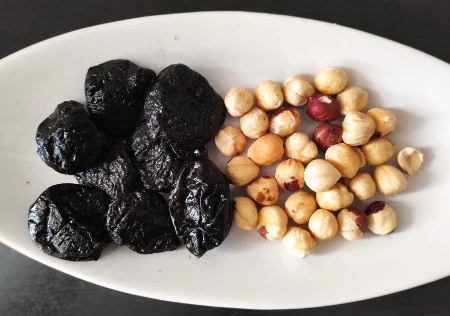 Prunes and hazelnuts on a plate
