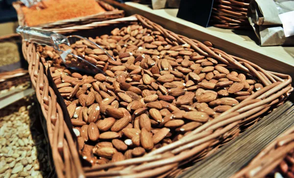 Shelled almonds in a bulk bin at a local market